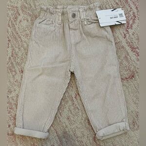 Blush pink corduroy pants with elastic waist.